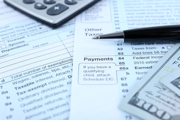Fototapeta premium 1040 Income Tax Form and dollar bills, close up