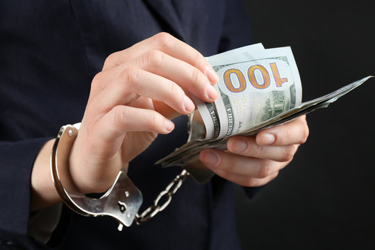 Man in handcuffs with money