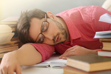 Young man fell asleep during reading.