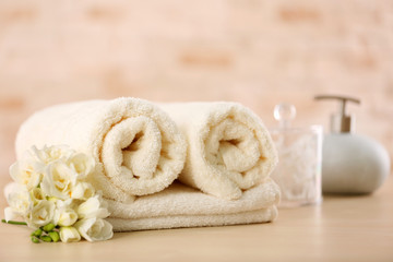 Fototapeta na wymiar Towels and bath accessories on table