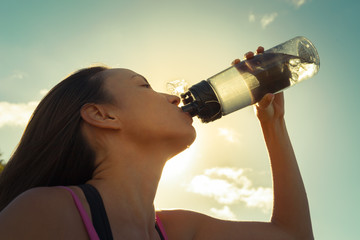 Woman drinking a bottle of water. 