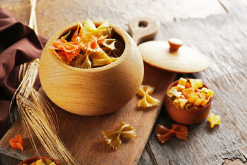 Raw pasta in bowl on table