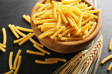 Uncooked pasta in bowl, closeup