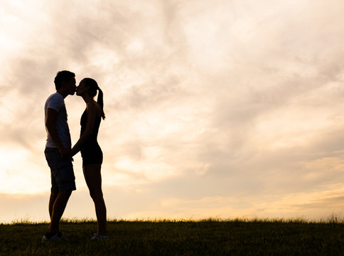 Young couple kissing outdoors. 