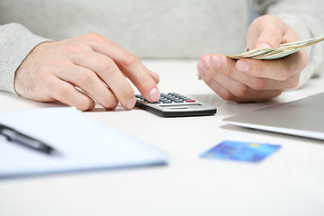 Man counting money and making calculations