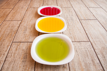 Colorful plates over white wooden table background with copy space