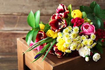 Bouquet of fresh flowers on a wooden box