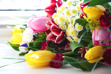 Bouquet of fresh flowers by the window