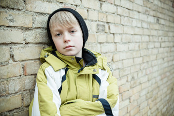 Child in coat with dejected expression