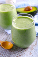 Avocado smoothie on wooden table closeup