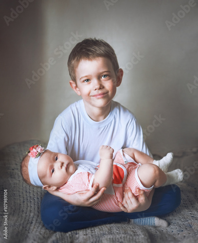 6 Year Old Boy Kissing His 3 Month Old Baby Sister Stock Photo And