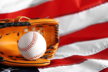 Baseball and glove on background of American flag. Popular sport concept