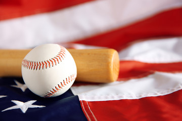Baseball and bat on background of American flag. Popular sport concept