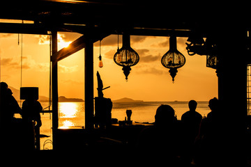 people at bar sunset background