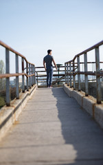 Tired after jogging. Concentrated young man resting after runnin