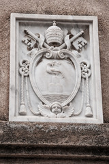 Marble coat of arms on the wall of a building