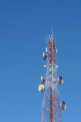 Telecommunication Radio Antenna and Satellite Tower with blue sk