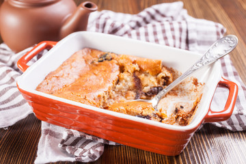 Fototapeta na wymiar cottage cheese casserole with dried fruits in a dish, selective focus