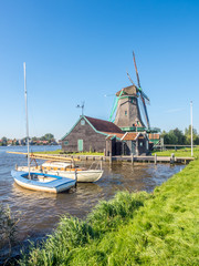 Fototapeta na wymiar Windmill with boats in Zaan Schans