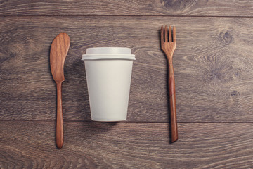 Coffee cup and wooden fork and knife.