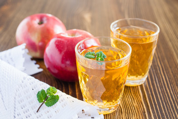 apples and juice on a table, selective focus