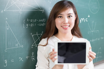 beautiful asian girl teacher with tablet and blackboard