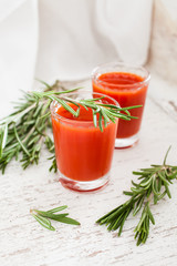 tomato juice in glasses on an old shabby background, selective focus