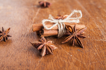 Cinnamon sticks and star anise on rustic wood