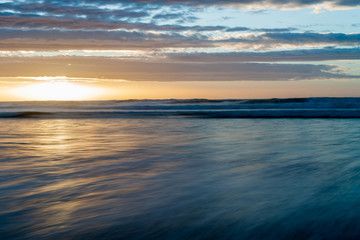 Fototapeta na wymiar Long exposure blurry abstract Waitarere Beach Levin New Zealand