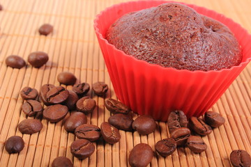 Fresh baked chocolate muffins and coffee grains
