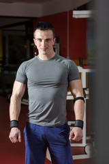 Portrait of muscular man with arms crossed in crossfit gym