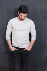 Handsome Young Man Smiling at the Camera Against chalkboard Wall