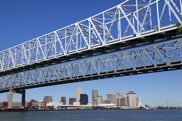 New Orleans,  Louisiana seen under the Crescent City Connection (twin cantilever style bridges) and the Mississippi River