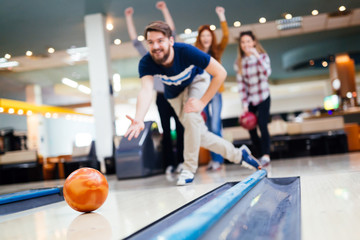 Naklejka premium Friends having fun while bowling