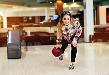 Woman throwing bowling ball