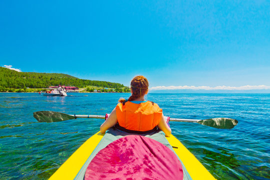 girl floats kayak on the river