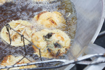 Thai food made from soy flour, bean sprouts, shrimp and egg while fried in big metal pan (Khanom Wug)