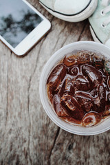 Cola with smart phone and sneakers