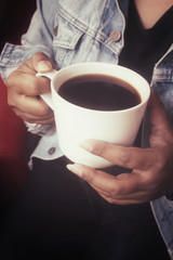 Woman drink black coffee with jeans jacket