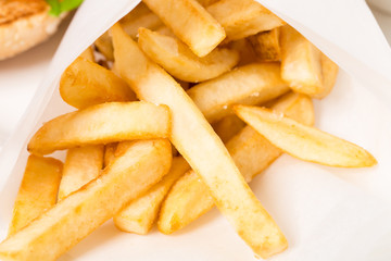 Closeup of french fries in a paper wrapper.