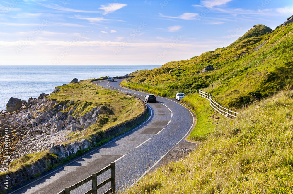 Wall mural The eastern coast of Northern Ireland and Antrim Coastal road with cars