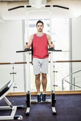 Fototapeta premium Muscular man doing pull up