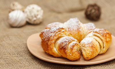 fresh three croissants on plate