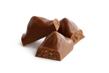 Pieces of chocolate closeup on white background 
