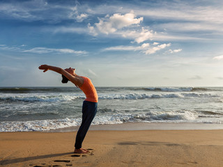 Fototapeta na wymiar Woman doing yoga Sun salutation Surya Namaskar 