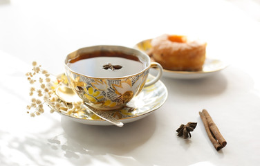 A cup of black tea with anise and cinnamon.