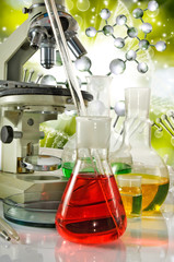 Image of laboratory glassware and microscopy on DNA strand background