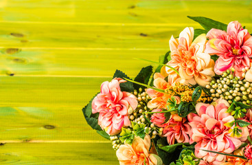 Mixed flowers bouquet on wood background.