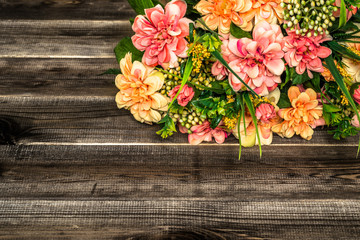 Mixed flowers bouquet on wood background.
