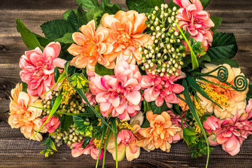 Mixed flowers bouquet on wood background.